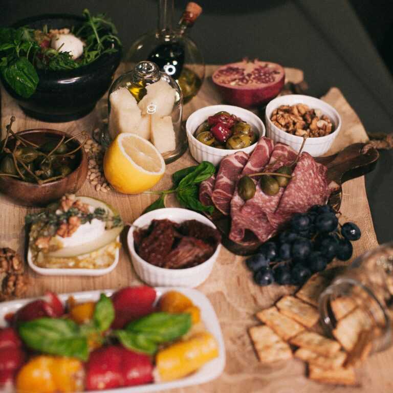 Delicious charcuterie board featuring fresh meats, cheeses, and fruits for a perfect dining experience.